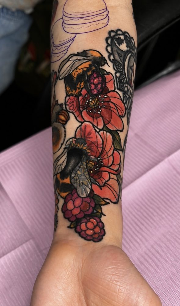 Neo-traditional bumblebees among red blossoms and raspberries