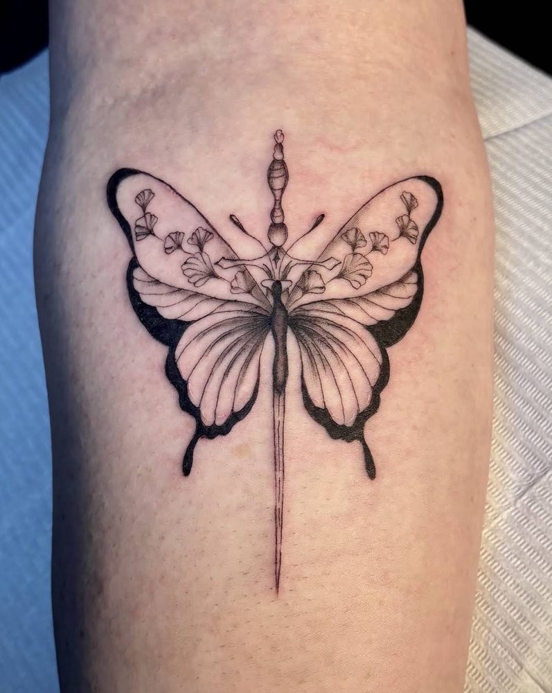 Fine-line butterfly with ginkgo-leaf detail and bold black wing accents