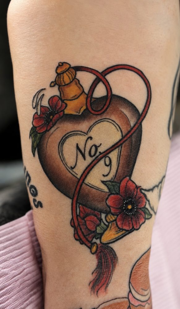Neo-traditional heart-shaped perfume bottle labeled No. 9 with poppies